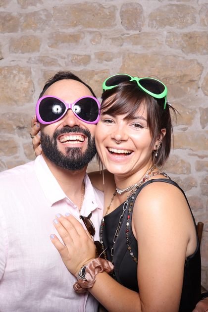 Cadrage vertical : un couple posant avec des lunettes fantaisie.
